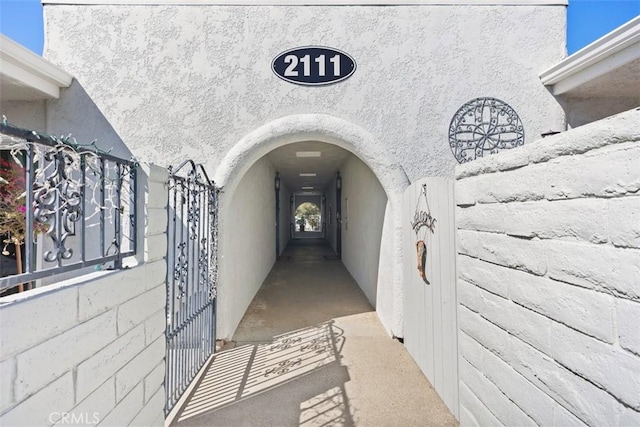 doorway to property featuring stucco siding