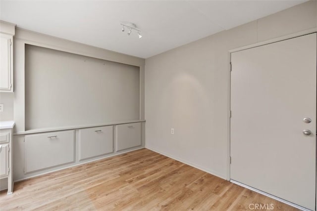 unfurnished bedroom with light wood-style floors