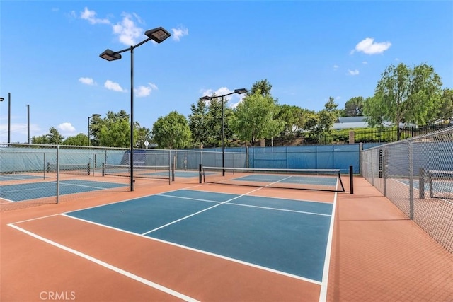 view of sport court featuring community basketball court and fence