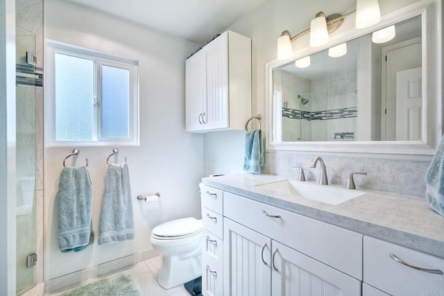 full bathroom featuring toilet, a stall shower, and vanity