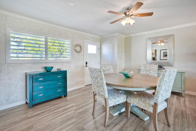 dining area with a ceiling fan, baseboards, crown molding, and light wood finished floors