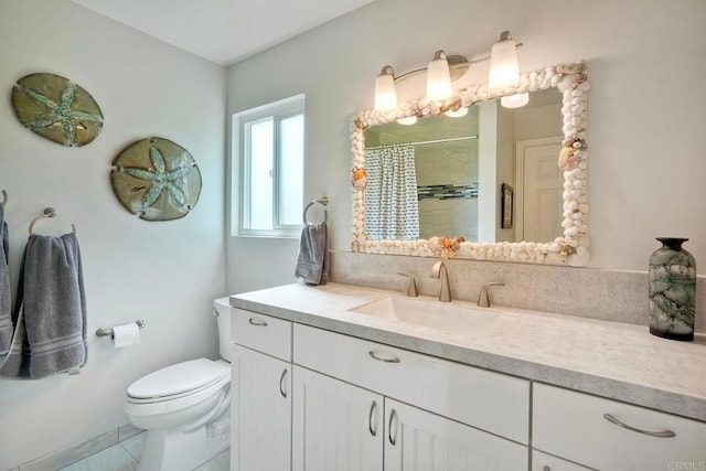 full bath featuring a tile shower, vanity, and toilet