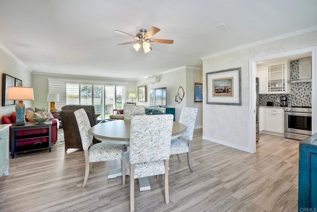 dining area with light wood-style floors, baseboards, ornamental molding, and ceiling fan