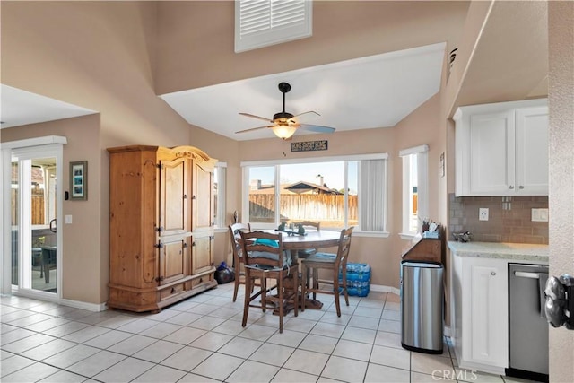 kitchen with light tile patterned floors, a ceiling fan, white cabinets, decorative backsplash, and dishwasher