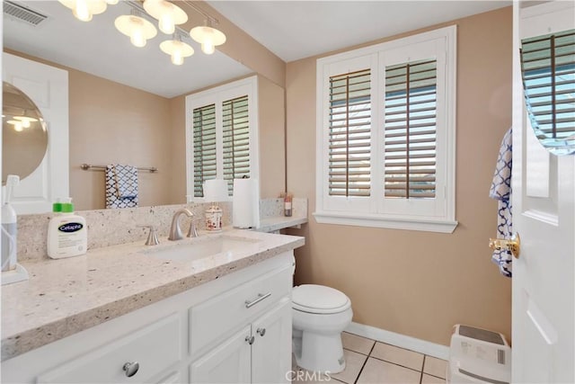 bathroom with visible vents, toilet, vanity, tile patterned flooring, and baseboards