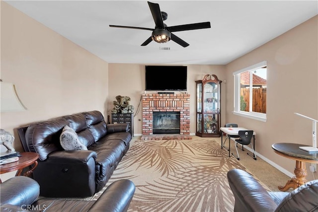 carpeted living room featuring a ceiling fan, visible vents, a fireplace, and baseboards