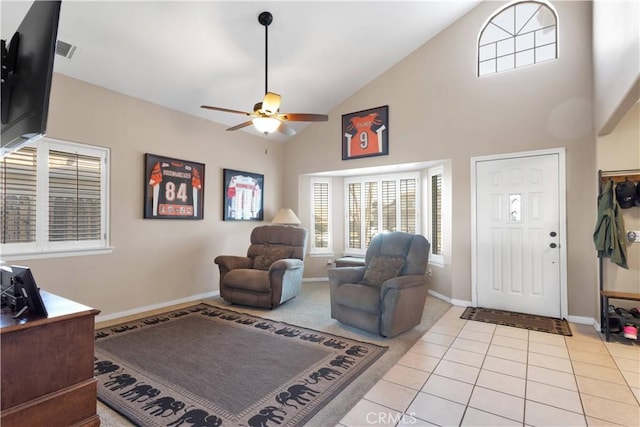 living room with baseboards, visible vents, a ceiling fan, high vaulted ceiling, and light tile patterned flooring