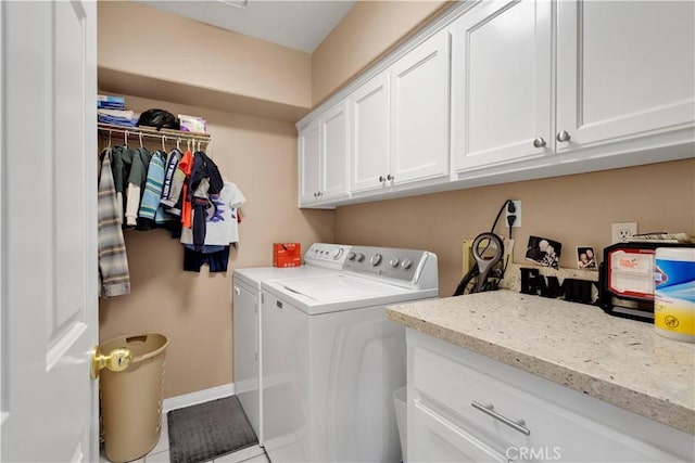 washroom with washing machine and clothes dryer, cabinet space, and baseboards