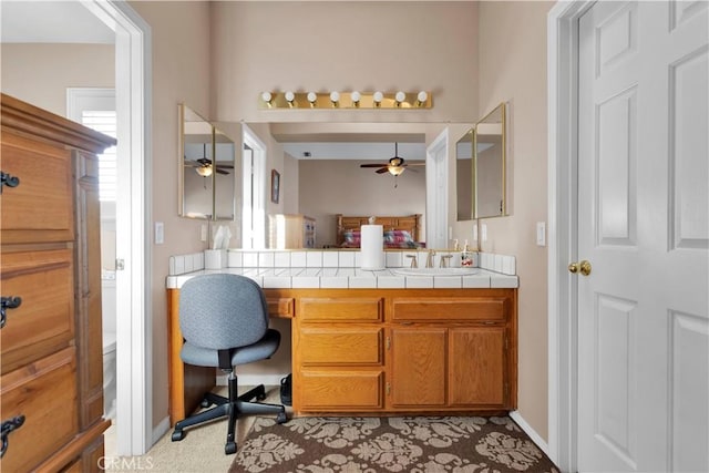 bathroom featuring toilet, baseboards, vanity, and a ceiling fan