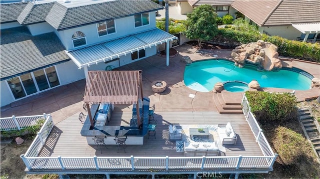 view of swimming pool featuring a pool with connected hot tub, outdoor dining area, fence, and an outdoor living space