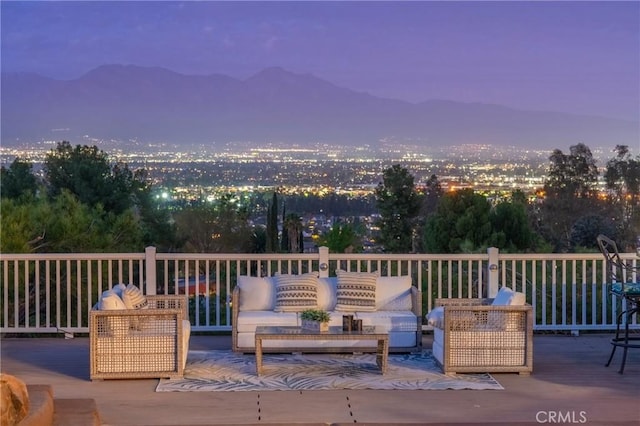 wooden deck with outdoor lounge area and a mountain view