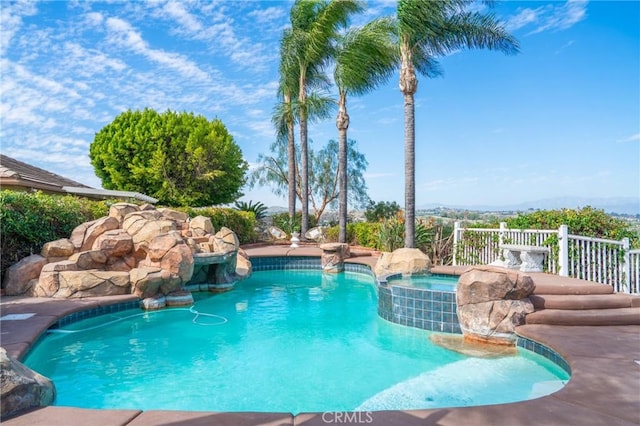 view of pool with a pool with connected hot tub