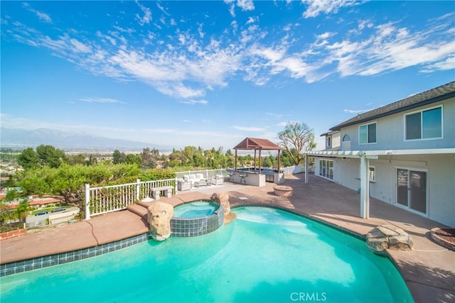 view of pool featuring a gazebo, a patio, fence, and a pool with connected hot tub