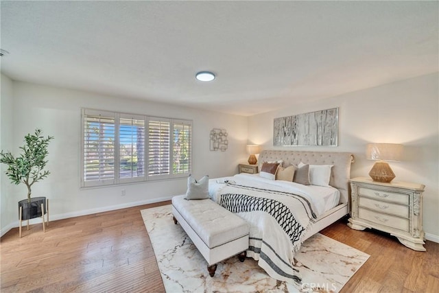 bedroom with wood finished floors and baseboards