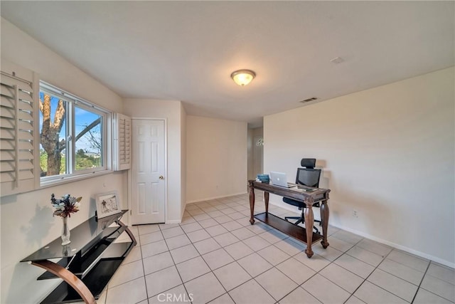 office space featuring light tile patterned floors, visible vents, and baseboards