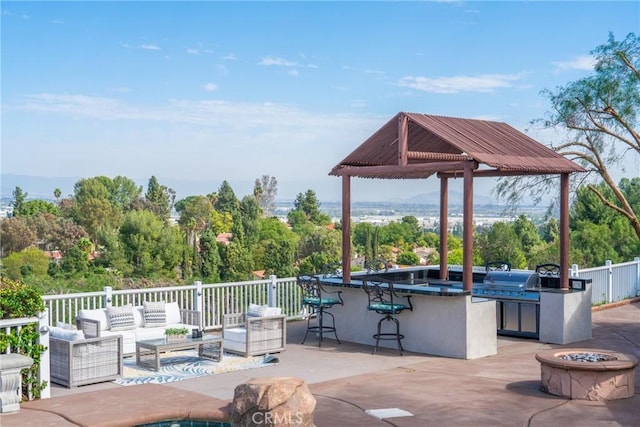 view of patio / terrace featuring outdoor dry bar, outdoor lounge area, area for grilling, a gazebo, and exterior kitchen