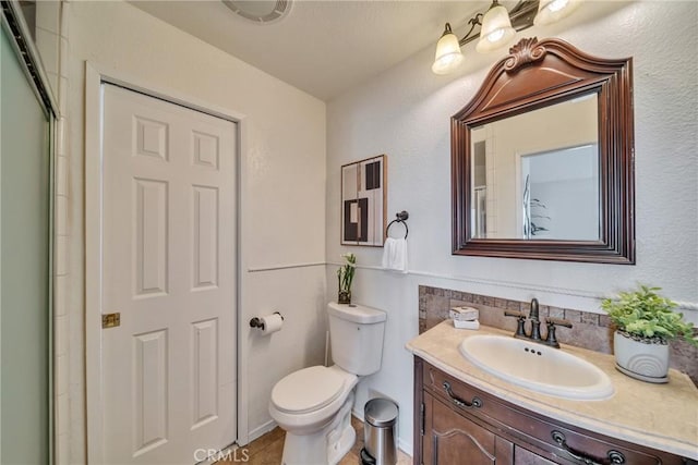 bathroom featuring toilet and vanity