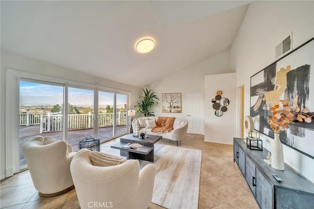 living area featuring visible vents, high vaulted ceiling, and light tile patterned flooring