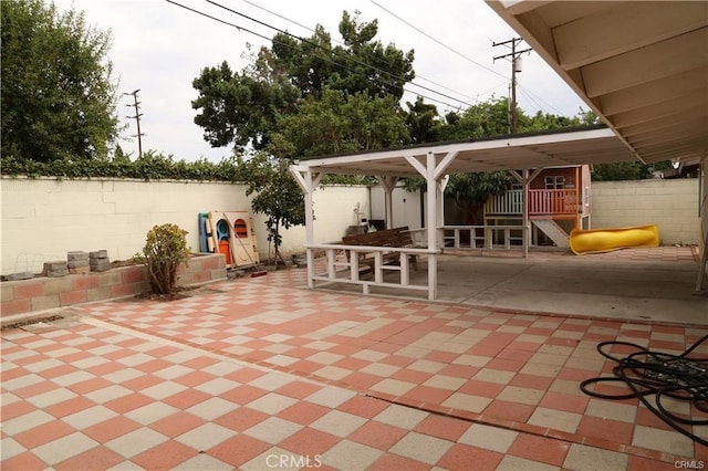 view of patio / terrace featuring fence and a playground