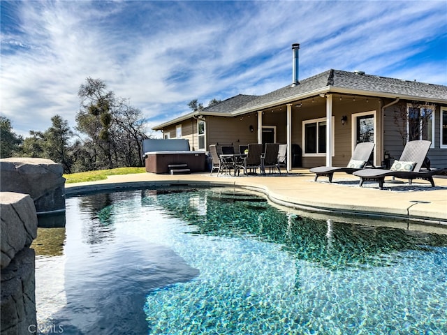 pool featuring a patio area and a hot tub