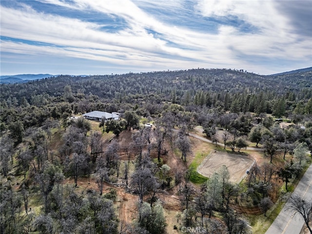 aerial view featuring a forest view and a mountain view