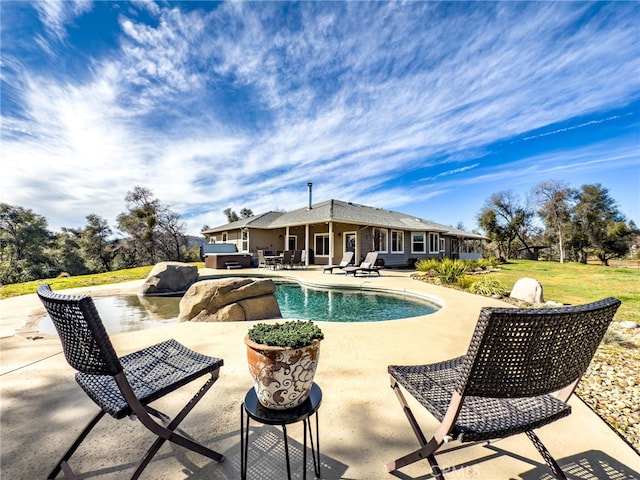 outdoor pool with a patio area