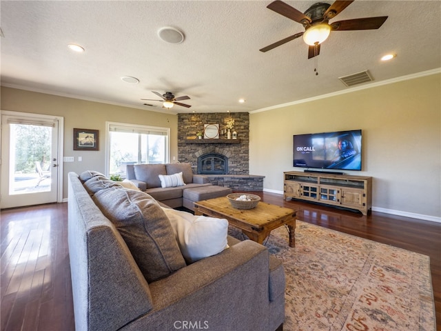 living room featuring visible vents, crown molding, a textured ceiling, and wood finished floors