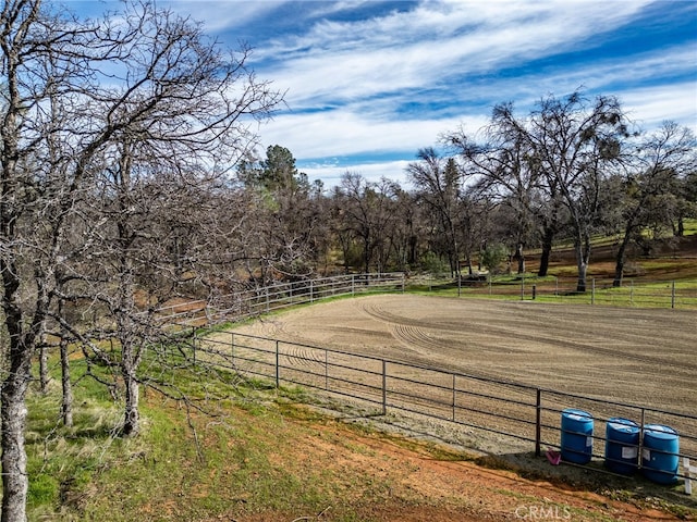 view of yard featuring an enclosed area and a rural view