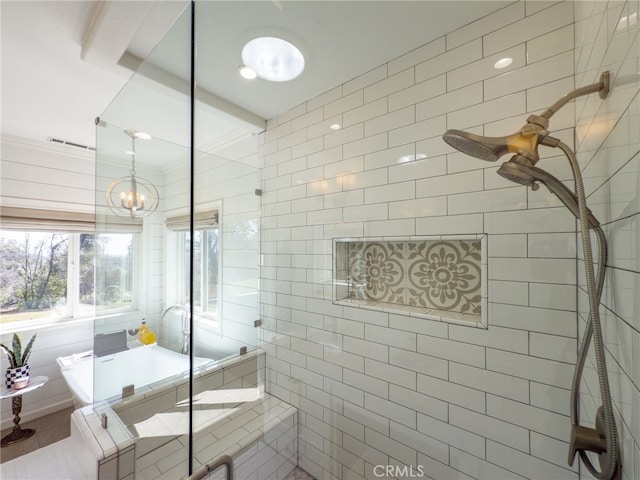 bathroom with tiled shower and visible vents