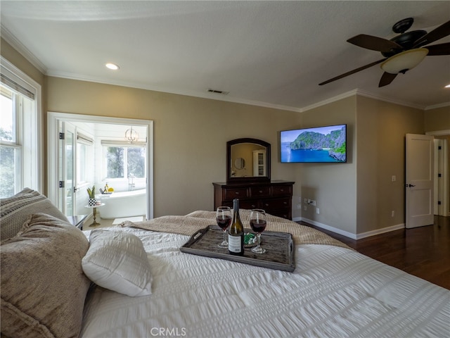 bedroom with visible vents, crown molding, baseboards, and multiple windows