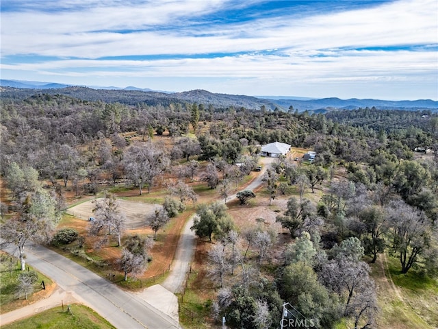 aerial view featuring a mountain view and a forest view