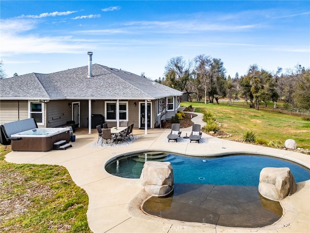 pool with a patio, a yard, area for grilling, and a hot tub