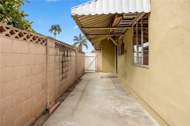 view of property exterior with fence and stucco siding