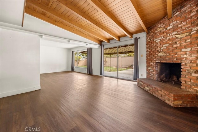 unfurnished living room featuring vaulted ceiling with beams, a brick fireplace, wood ceiling, and wood finished floors