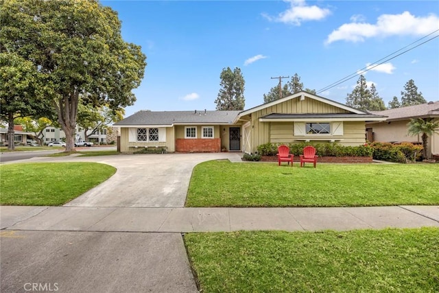 ranch-style home with concrete driveway and a front yard