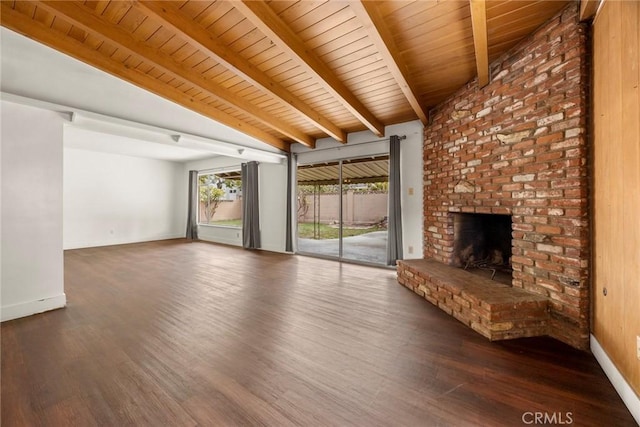 unfurnished living room with lofted ceiling with beams, a fireplace, wood finished floors, wood ceiling, and baseboards