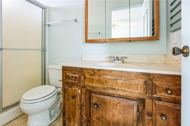 bathroom with toilet, an enclosed shower, and vanity