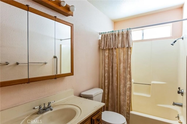 bathroom with shower / bath combo, vanity, and toilet