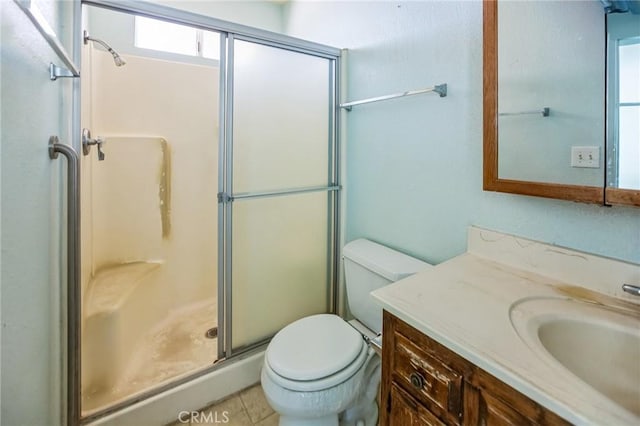 bathroom featuring a stall shower, vanity, and toilet