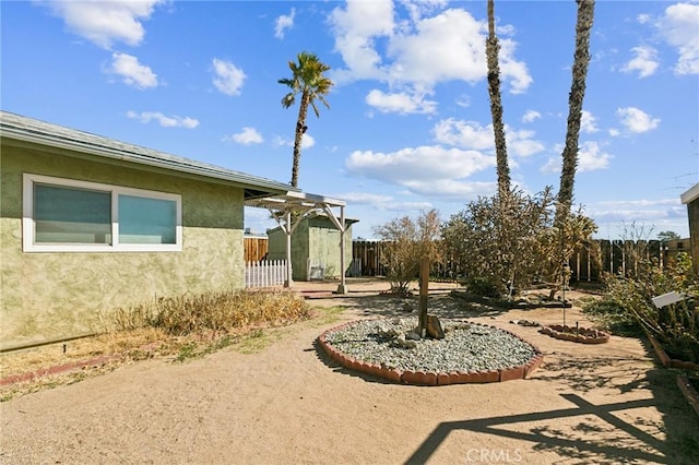 view of yard with a storage unit, an outdoor structure, and a fenced backyard