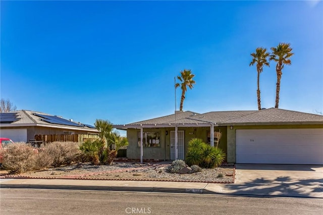 ranch-style home featuring a garage, concrete driveway, and stucco siding