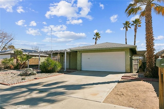 single story home featuring driveway, an attached garage, and stucco siding