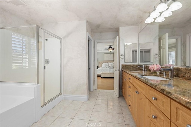 bathroom with tile patterned flooring, a shower stall, vanity, and ensuite bathroom