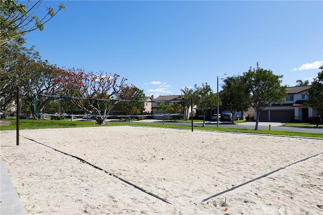 surrounding community with volleyball court and a residential view