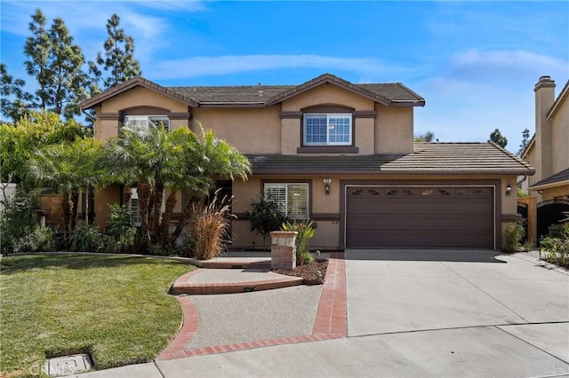 traditional home with concrete driveway, a front lawn, a tiled roof, and stucco siding