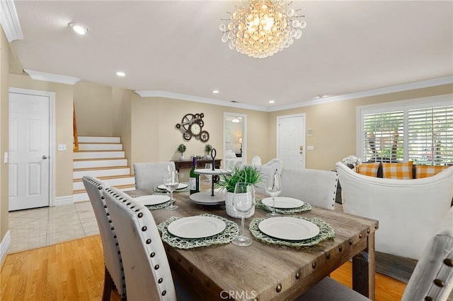 dining area featuring a notable chandelier, crown molding, recessed lighting, light wood-type flooring, and stairs