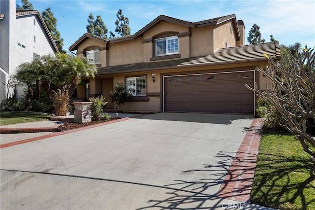 traditional home featuring a garage, concrete driveway, a tile roof, and stucco siding