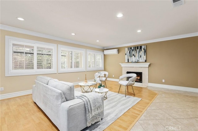 living area featuring ornamental molding, baseboards, a fireplace with flush hearth, and a wall mounted AC