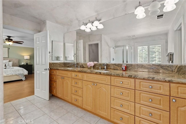 bathroom with double vanity, visible vents, connected bathroom, tile patterned floors, and a sink