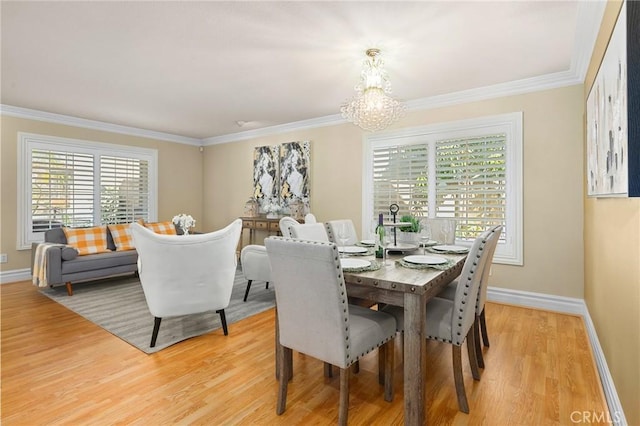 dining space with crown molding, light wood finished floors, and a healthy amount of sunlight